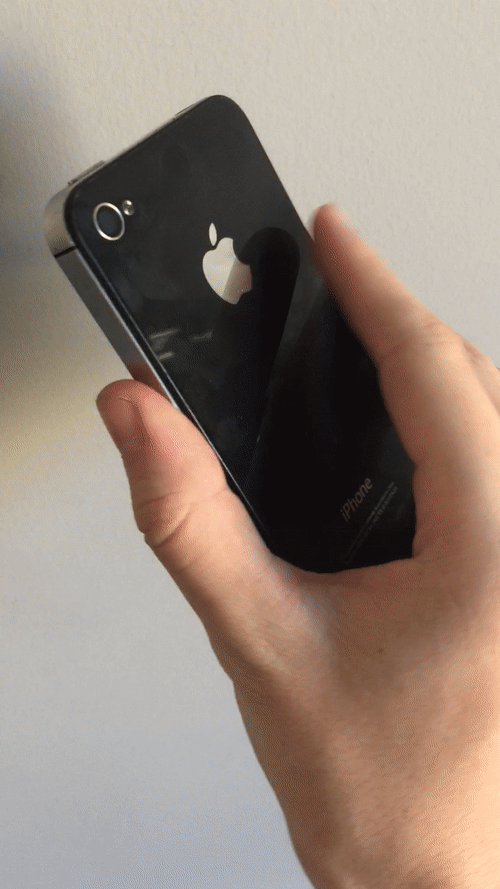 An old iphone with the screen removed and a set of naked buttons put in its place with black Sugru smeared around them