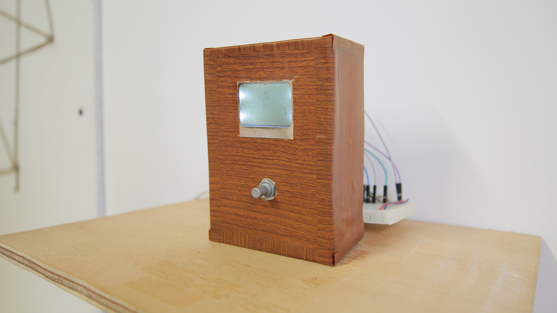 Device quarter view showing exposed wires behind
